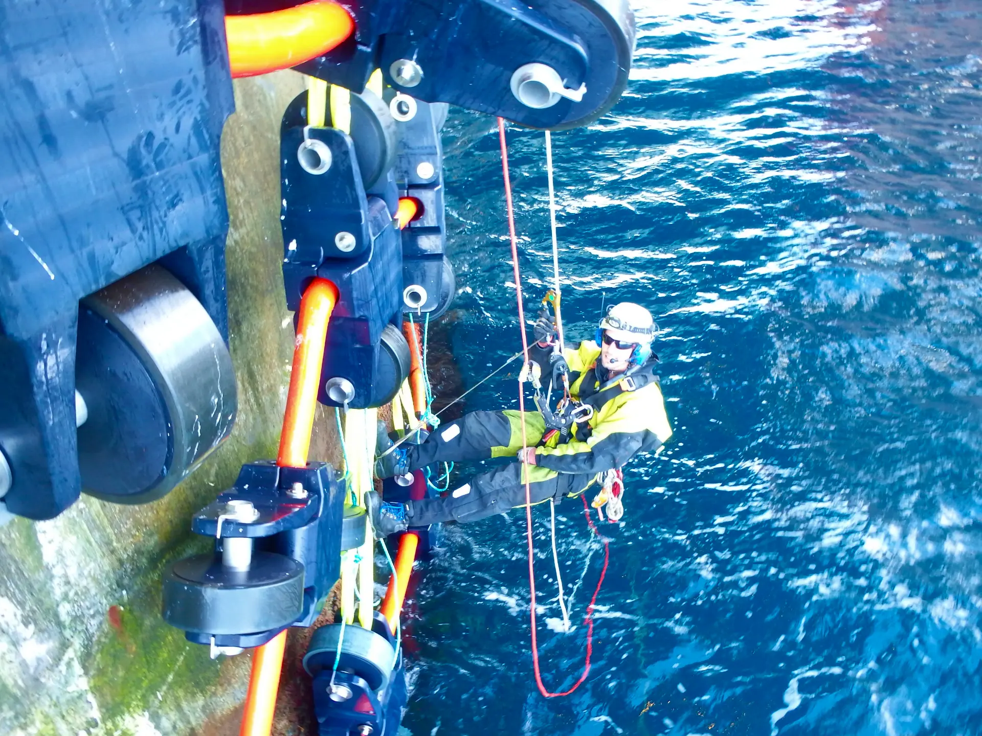 Prosik rope access technician on ropes alongside an offshore structure by the sea.